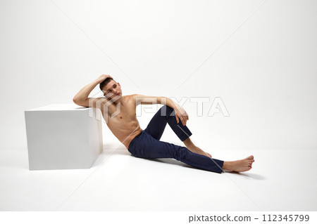 Handsome young guy with healthy, relief, muscular body posing in jeans isolated over white studio background Handsome young guy with healthy, relief, muscular body posing in jeans isolated over white studio background 112345799