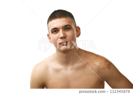 Portrait of handsome young guy with well-kept skin standing shirtless and looking at camera isolated over white studio background 112345879