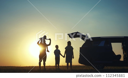 family traveling by car. family watching the sunset silhouette next to the car in the park. happy family kid dream concept. people in the park. family car camping resting lifestyle in nature family traveling by car. family watching the sunset silhouette next to the car in the park. happy family kid dream concept. people in the park. family car camping resting lifestyle in nature 112345881