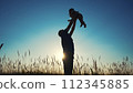 father throws play baby in the park. father's day silhouette happy family child dream concept. father plays with baby throws up. dad play his son in nature in the lifestyle park silhouette at sunset 112345885