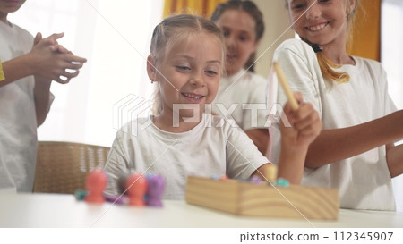 child group playing fishing lifestyle. children in kindergarten play with toys. happy family kid dream concept. a group of children collect building blocks in a kindergarten indoors child group playing fishing lifestyle. children in kindergarten play with toys. happy family kid dream concept. a group of children collect building blocks in a kindergarten indoors 112345907