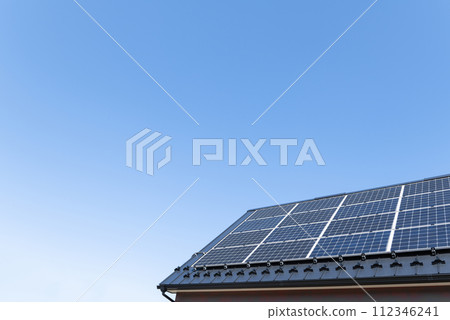 Residential roofs with solar panels installed and a clear blue sky. Residential roofs with solar panels installed and a clear blue sky. 112346241