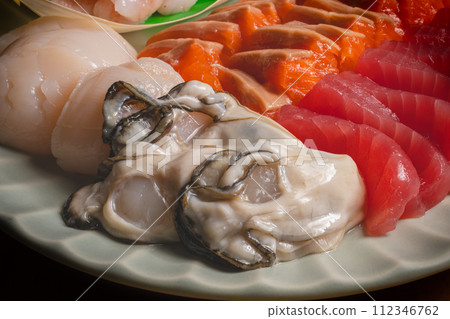 Assorted seafood sashimi, tuna, salmon, shrimp, scallops, oysters 112346762