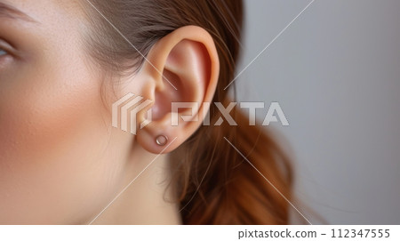 Close-up View of Woman's Ear with Elegant Silver Earring, Fashion Jewelry Portrait Shot Close-up View of Woman's Ear with Elegant Silver Earring, Fashion Jewelry Portrait Shot 112347555