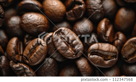 Roasted coffee beans closeup - A pile of freshly roasted beans ready for grinding and brewing Roasted coffee beans closeup - A pile of freshly roasted beans ready for grinding and brewing 112347568