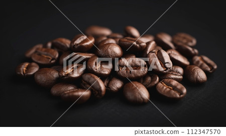 Close-up of Dark Brown Roasted Coffee Beans on Black Background with Shiny Texture Close-up of Dark Brown Roasted Coffee Beans on Black Background with Shiny Texture 112347570