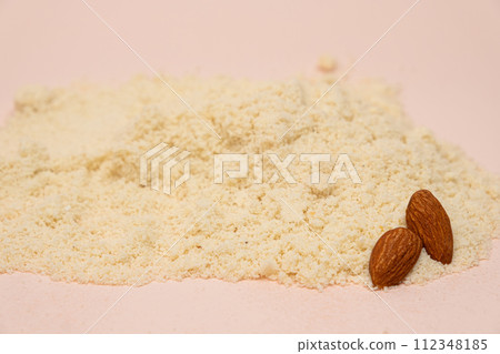 Almond flour and almonds on a beige background Almond flour and almonds on a beige background 112348185