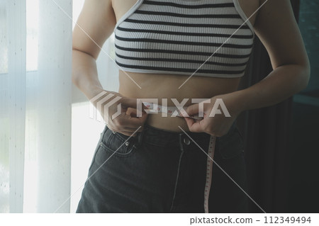 Women body fat belly. Obese woman hand holding excessive belly fat. diet lifestyle concept to reduce belly and shape up healthy stomach muscle. 112349494