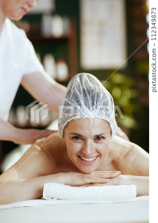 massage therapist in massage cabinet massaging clients back massage therapist in massage cabinet massaging clients back 112349873