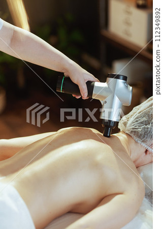 Closeup on medical massage therapist massaging clients neck Closeup on medical massage therapist massaging clients neck 112349892