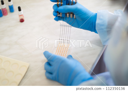 Examination of blood samples with a special syringe in the laboratory 112350136