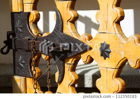 An old bolt. An ancient castle from the door. Retro key. The door bolt is iron historical 112350183