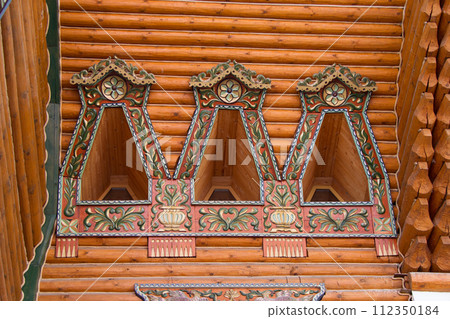 Wooden architecture. Russian block. Painted windows of ancient buildings 112350184