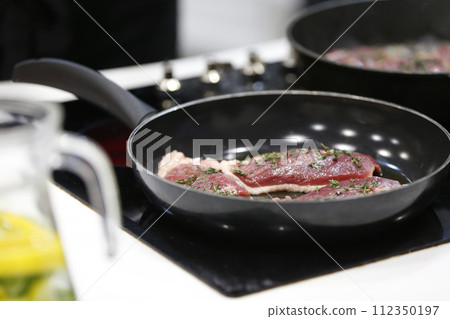 Fry meat in a frying pan.Fry the duck. Preparation of meat dishes. Fry meat in a frying pan.Fry the duck. Preparation of meat dishes. 112350197