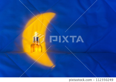 Night Skin Care Concept, Circadian Rhythms, Melatonin, CBD Oil for Sleep. A bottle with a pipette in the moonlight on a blanket in the bedroom. Minimal background for sleeping, copy space Night Skin Care Concept, Circadian Rhythms, Melatonin, CBD Oil for Sleep. A bottle with a pipette in the moonlight on a blanket in the bedroom. Minimal background for sleeping, copy space 112350249