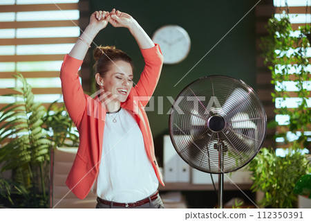 smiling modern bookkeeper woman in modern green office dancing smiling modern bookkeeper woman in modern green office dancing 112350391