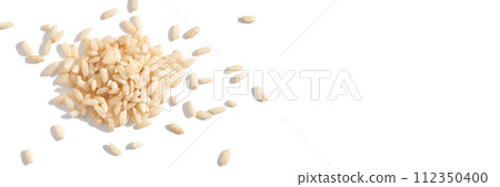 A top view of raw brown and white rice, forming a heap. The integral, uncooked A top view of raw brown and white rice, forming a heap. The integral, uncooked 112350400