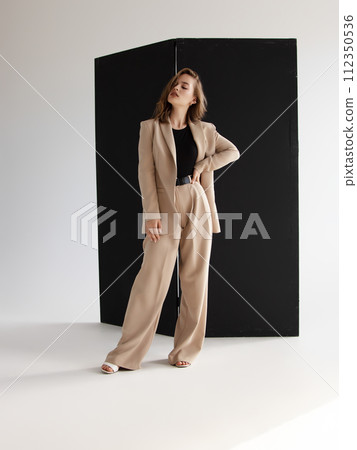 Fashionable confident woman wearing elegant suit Fashionable confident woman wearing elegant suit 112350536