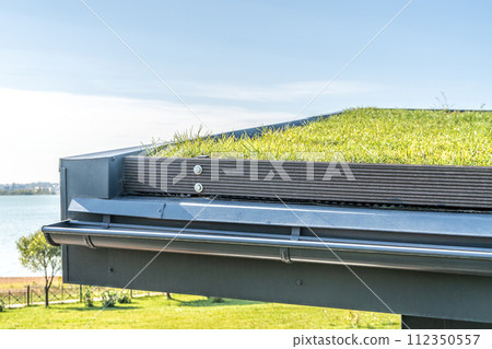 Guest house with metal rebated facade and lawn on flat roof 112350557