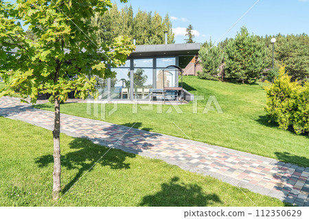 Guest house with glass walls and barbeque zone in yard Guest house with glass walls and barbeque zone in yard 112350629