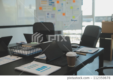 Laptop on a desk in an open financial office. Laptop on a desk in an open financial office. 112350678