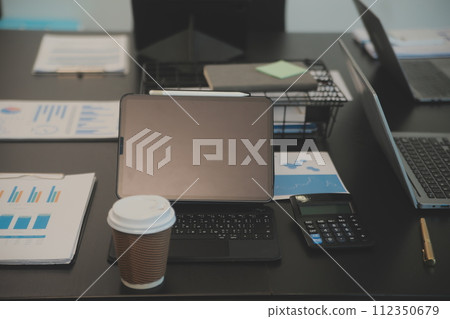 Laptop on a desk in an open financial office. Laptop on a desk in an open financial office. 112350679