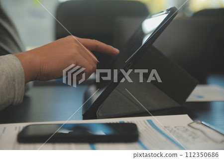 Laptop on a desk in an open financial office. Laptop on a desk in an open financial office. 112350686