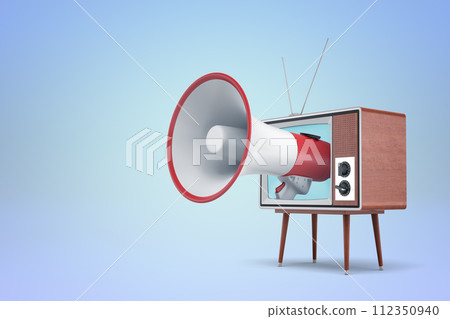 Megaphone emerging from vintage TV on blue backdrop Megaphone emerging from vintage TV on blue backdrop 112350940