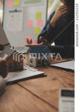 Real estate agent and Sales manager team analysis pricing of rental lease contract of sale purchase agreement, concerning mortgage loan offer for and house insurance. 112351219