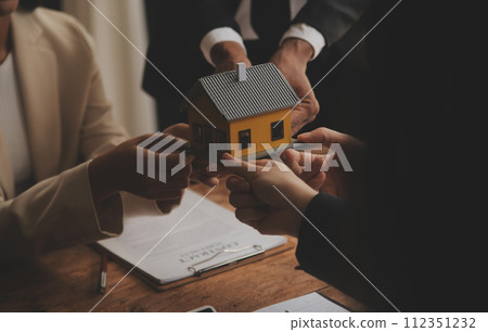 Real estate agent and Sales manager team analysis pricing of rental lease contract of sale purchase agreement, concerning mortgage loan offer for and house insurance. 112351232