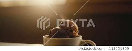 Delicious cup of ice cream sits on table in front of window, basking in natural light. For advertising, banner, relaxation, lifestyle, menu, food, dessert, culinary or cafe themed content. Copy space. 112351869