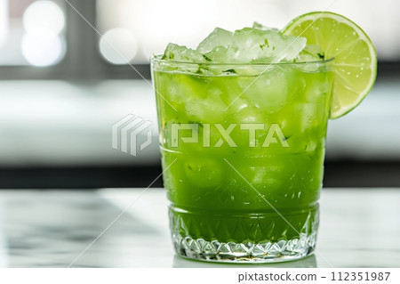 Matcha Margarita with ice and sprinkled with matcha powder in the kitchen on the table 112351987