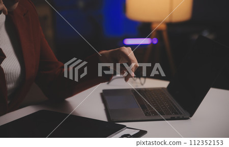 Business woman using calculator for do math finance on wooden desk in office and business working background, tax, accounting, statistics and analytic research concept 112352153