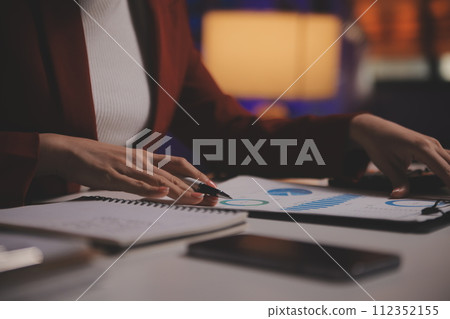 Business woman using calculator for do math finance on wooden desk in office and business working background, tax, accounting, statistics and analytic research concept Business woman using calculator for do math finance on wooden desk in office and business working background, tax, accounting, statistics and analytic research concept 112352155