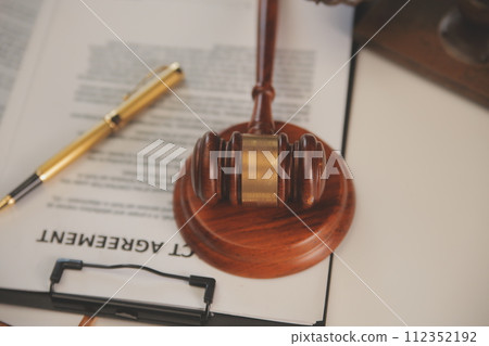 image of judge's hammer, scales lady of justice, law book, laptop computer and contract documents with pen concept of law and justice. 112352192
