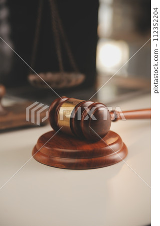 image of judge's hammer, scales lady of justice, law book, laptop computer and contract documents with pen concept of law and justice. 112352204