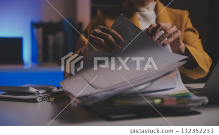 Business woman using calculator for do math finance on wooden desk in office and business working background, tax, accounting, statistics and analytic research concept Business woman using calculator for do math finance on wooden desk in office and business working background, tax, accounting, statistics and analytic research concept 112352231