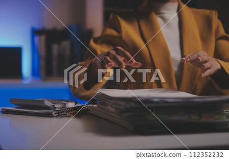 Business woman using calculator for do math finance on wooden desk in office and business working background, tax, accounting, statistics and analytic research concept Business woman using calculator for do math finance on wooden desk in office and business working background, tax, accounting, statistics and analytic research concept 112352232