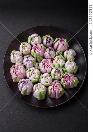 Beautiful tasty marshmallows in the form of tulip buds Beautiful tasty marshmallows in the form of tulip buds 112352551