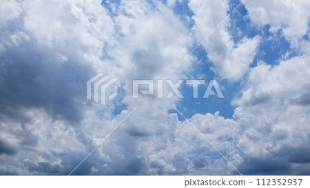 Many clouds flowing in the summer blue sky Many clouds flowing in the summer blue sky 112352937