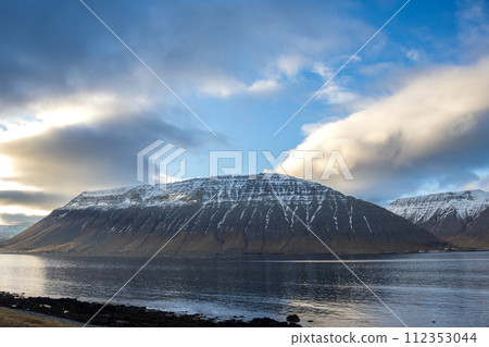 Fjord, mountains and cloudy sky, Iceland 112353044