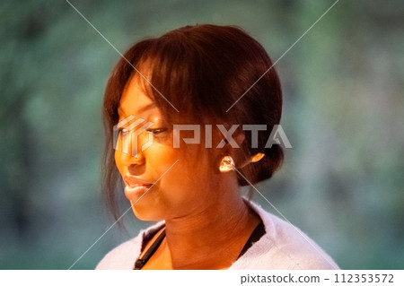 Pensive African American Woman with Elegant Earrings Pensive African American Woman with Elegant Earrings 112353572