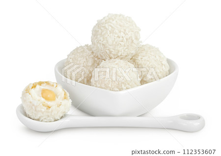 round candy raffaello with coconut flakes and nut in ceramic bowl isolated on white background 112353607