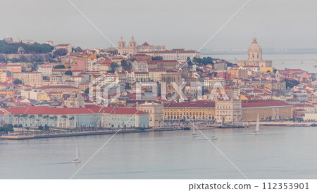 Aerial view of colorful orange roofs of the Alfama district and the Comercio Square timelapse of Lisbon, Portugal Aerial view of colorful orange roofs of the Alfama district and the Comercio Square timelapse of Lisbon, Portugal 112353901