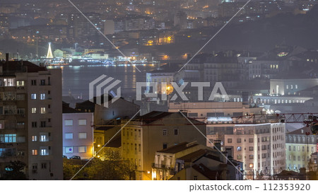 Aerial view of Lisboa downtown night timelapse. Panoramic of Baixa, Rossio and Chiado red rooftops from above. Portugal 112353920