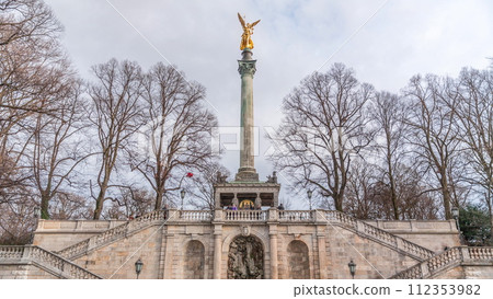 Front view of famous Peace Column with golden Angel of Peace statue timelapse. Germany, Munich 112353982