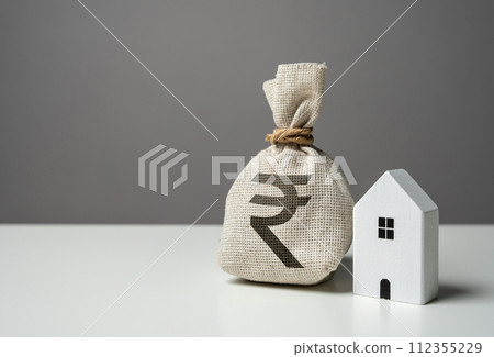 House and indian rupee money bag. Investments in the purchase of real estate. Repair and service. Make a deal. Insurance. House price, property valuation. 112355229