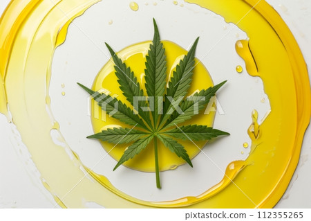 Idealistic cannabis leaf on white background in smooth neat circle of yellow hemp oil, minimalist, aesthetic, simple. Top view. Medicinal marijuana in beauty industry. CBD, CBN oil concept 112355265
