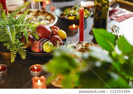Cozy holiday table setting with different delicious food and beverages ready for friends home party 112355304