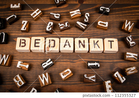 Thank you in Dutch. Alphabet blocks on wood texture background 112355327